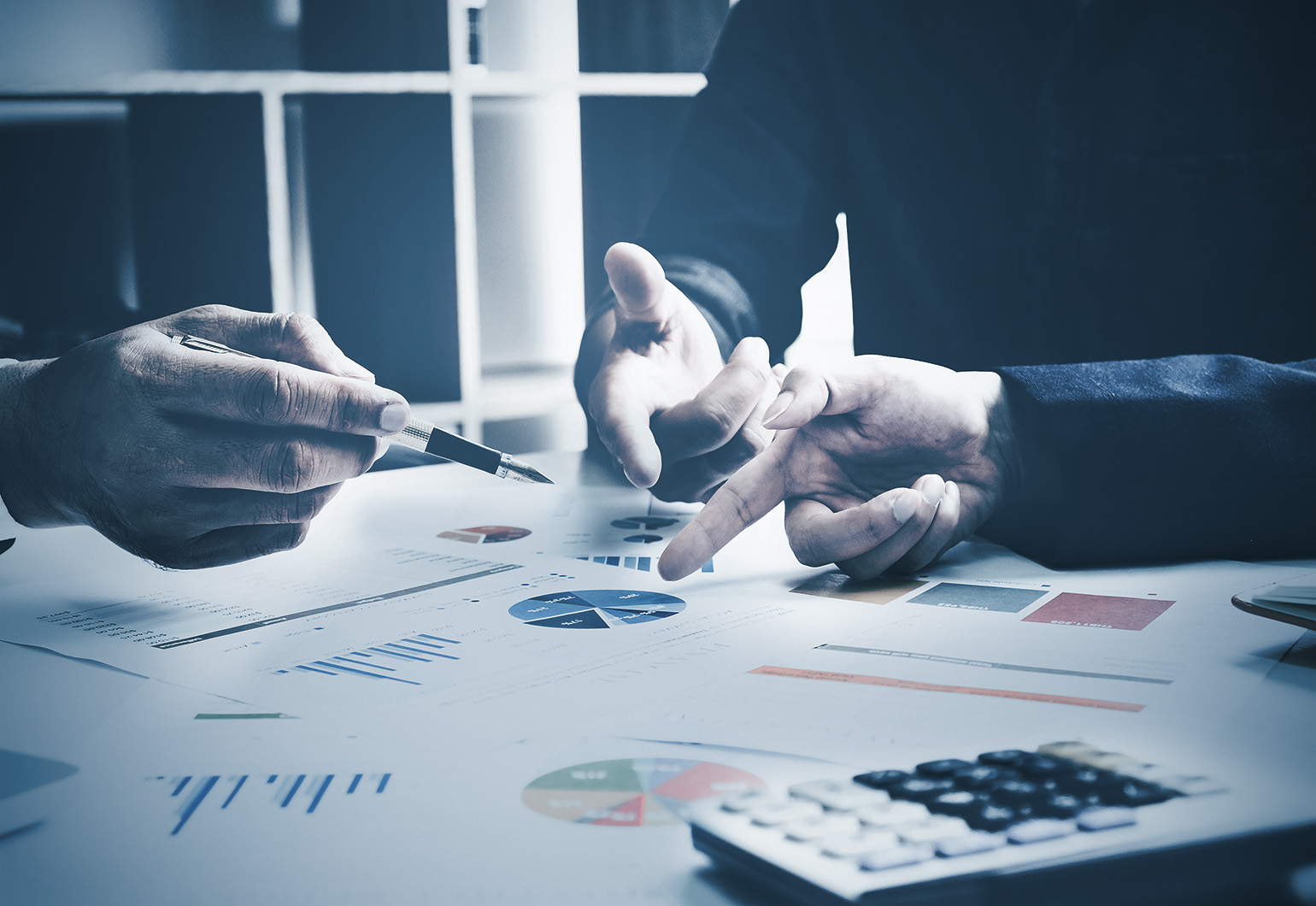 People meeting with charts and paperwork